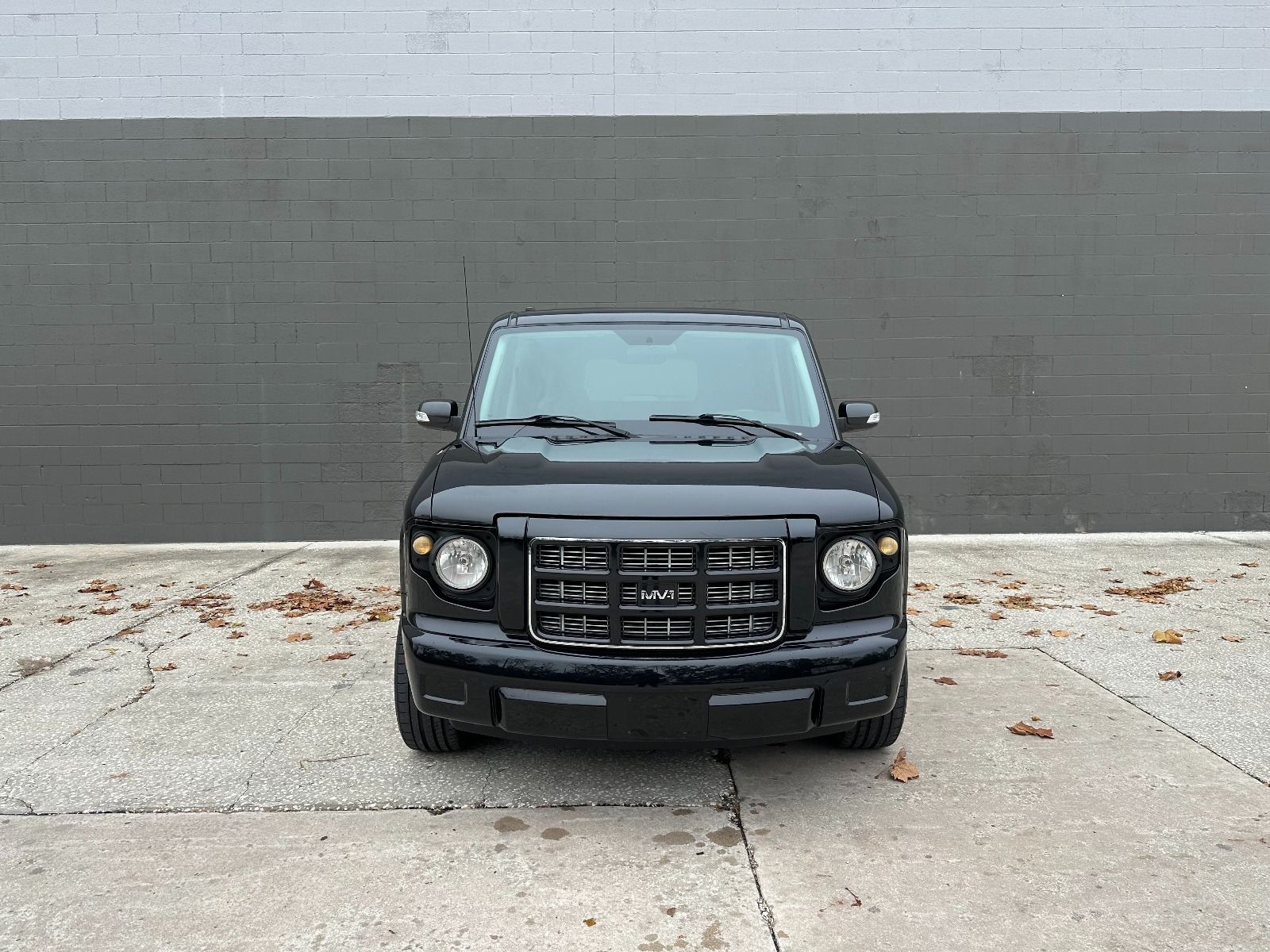 Black Ford Explorer wheelchair accessible SUV with the ramp deployed from the open passenger side rear door.
