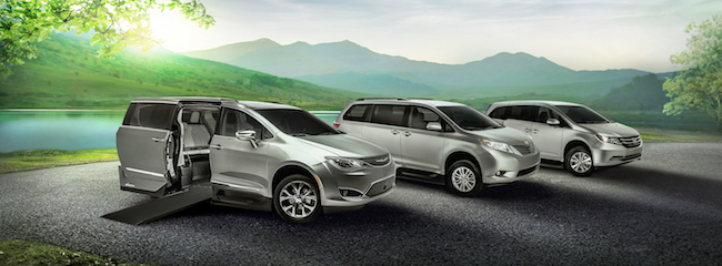 A Chrysler, Toyota, and Honda wheelchair van parked side by side. All are silver in color.